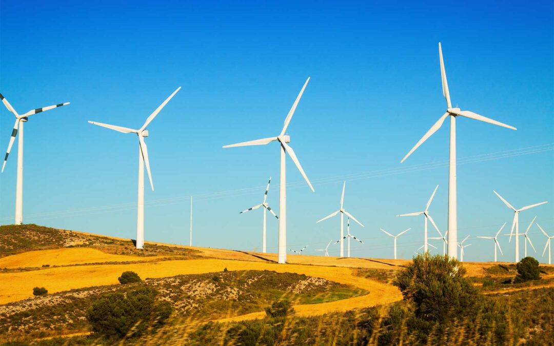 Wind farm at farmland in summer. Aragon